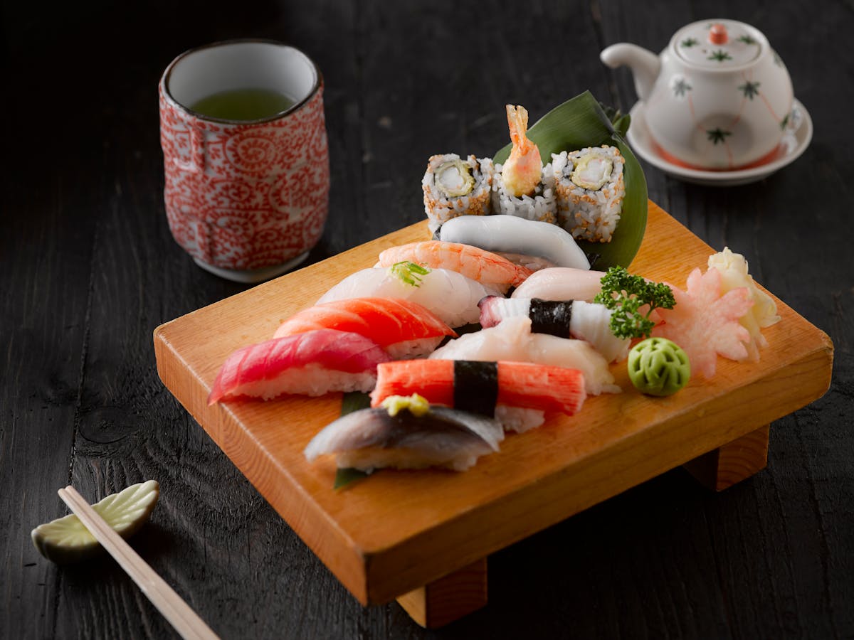 Assorted nigiri sushi platter with green tea