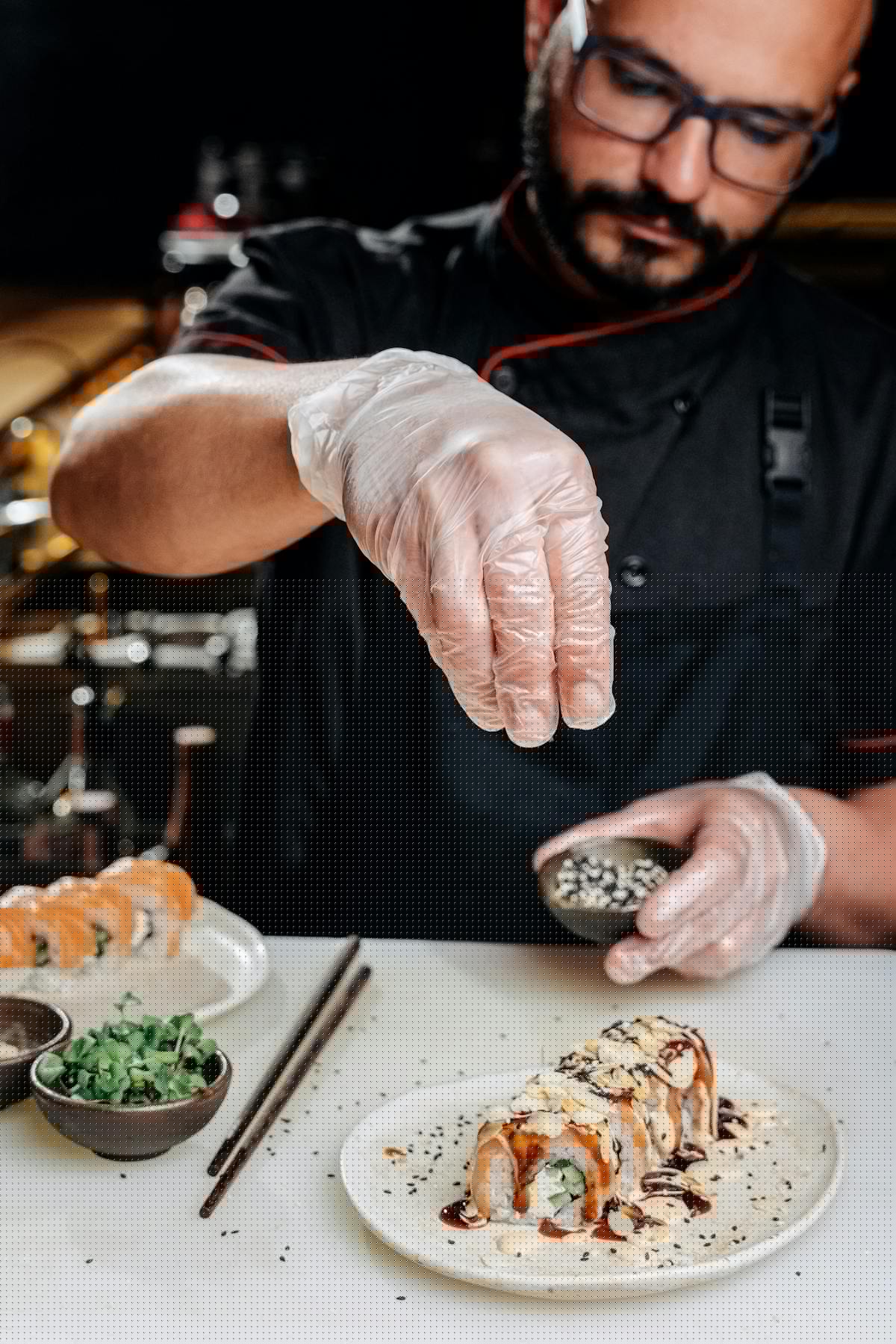 Chef preparing sushi rolls